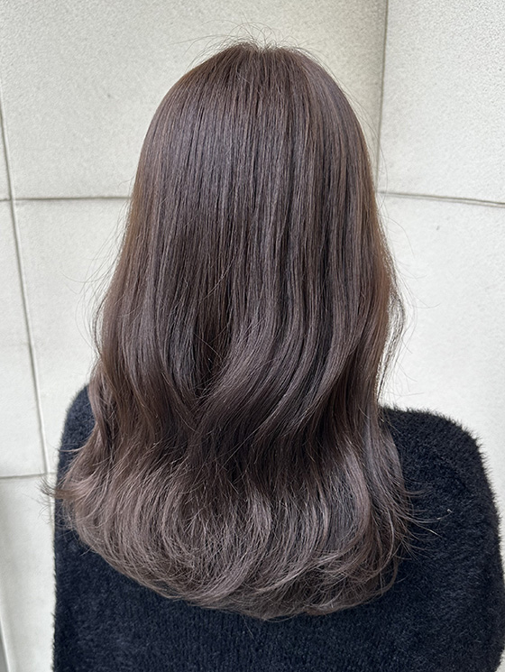 髪色がチャコールベージュの女性の後ろ姿